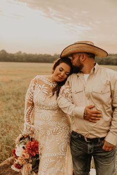 a man and woman standing next to each other in a field