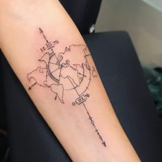 a person with a tattoo on their arm has a world map tattooed on the arm