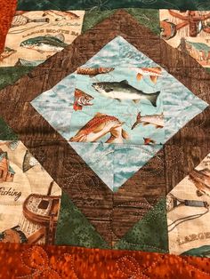 a quilted table topper with fish on it