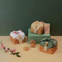 three baskets are sitting on top of each other and decorated with ribbons, beads, and flowers