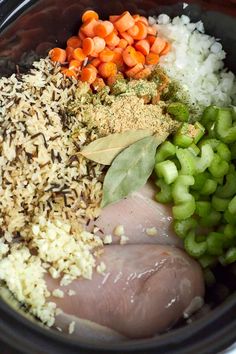 an assortment of ingredients in a slow cooker to make chicken and rice casserole