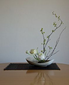 there is a vase with flowers in it on the table