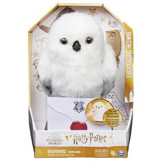 a white stuffed animal in a harry potter box