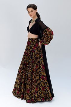 Black silk organza lehenga with floral pattern. Comes with a blouse and a long jacket.
Components: 3
Type Of Work: Floral
Neckline: Jacket : Stand collar, Blouse : V Neck
Sleeve Type: Jacket : Puffed Sleeves, Blouse : Sleeveless
Fabric: Silk organza
Color: Black
Other Details: 
Side slits on jacket
Closure : Front hooks
Occasion: Cocktail, Destination Wedding - Aza Fashions Designer Floral Print Organza Choli, Floral Print Organza Choli For Party, Fitted Floral Print Organza Sets, Elegant Organza Choli With Floral Print, Elegant Floral Print Organza Choli, Elegant Fitted Floral Print Choli, Black Georgette Lehenga With Floral Embroidery, Fitted Organza Lehenga With Floral Print, Fitted Floral Print Organza Lehenga