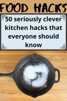 a frying pan filled with food on top of a wooden counter next to a sign