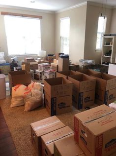 many boxes are stacked on the floor in an empty room with no people around them