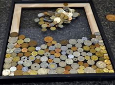 a wooden frame filled with lots of coins