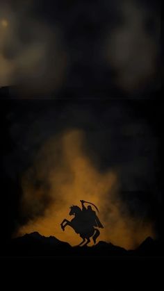 the silhouette of a man on a horse is shown