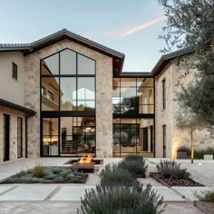 a modern home with stone and glass exterior