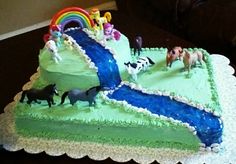 a birthday cake with horses and rainbows on it