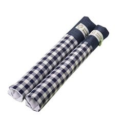 two blue and white checkered napkins sitting on top of each other