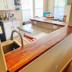 a kitchen with an island counter top next to a sink