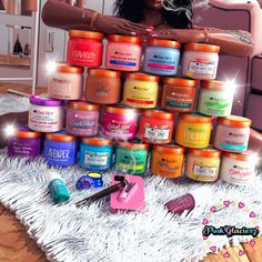 a woman standing in front of a pile of jars and manicures on top of a table