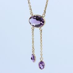 "Vintage Minimalist Lavalier Necklace in 14k Gold with Bezel Set, Oval Cut, Amethysts. This necklace bears a makers hallmark with \"rings and the letter A\", there is also a 14k Purity mark, no origin mark. Necklace measures 15.75\" Total Drop of Lavalier Pendant 1.75\" 1X - 13.6x9.8x5.85 mm Large Amethyst Oval Gem 2X - 7x4.5x3.75 mm Small Amethyst Oval Gems Total weight of necklace 0.179 Oz (78.1 g) This item is vintage. It has been cherished, worn, and preserved by possibly many over the decad Formal Drop Necklace With Bezel Setting, Formal Drop Necklaces With Bezel Setting, Delicate Hallmarked Necklaces For Formal Occasions, Formal Briolette Necklace With Bezel Setting, Dainty Briolette Necklace For Formal Occasions, Formal Yellow Gold Drop Necklace With Gemstone, Formal 14k Gold Drop Necklaces, Delicate Oval Pendant Necklace For Formal Occasions, Dainty 14k Gold Drop Necklace For Formal Occasions