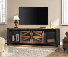 a flat screen tv mounted to the side of a wooden entertainment center in a living room