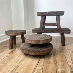 two wooden stools sitting on top of a hard wood floor next to each other