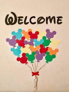 a bunch of balloons with the word welcome written on them