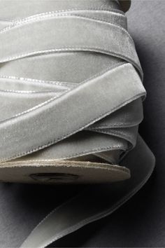 a roll of silver satin ribbon on top of each other