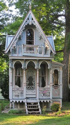 a white house with a blue roof and porch