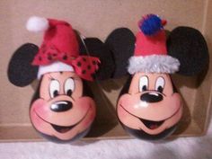 two mickey and minnie mouse christmas ornaments in a box