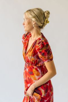 The Fannon Floral Midi Dress in Red Multi is sure to turn heads with its vibrant colors and playful floral pattern. With a comfortable and flattering midi length, this dress is perfect for any occasion. Bring a touch of whimsy to your wardrobe with this one-of-a-kind dress. Details self/lining: 100% polyester Fabric Care Guide Here Sizing & Fit Measurements are approximate and taken while laying flat across the front. Not doubled. small: bust = 18"; length = 48" medium: bust = 19"; length = 48.5 Vibrant V-neck Midi Dress For Brunch, Red Floral Print Knee-length Dress, Fitted Red Floral Dress For Spring, Red Knee-length Dress With Floral Print, Red V-neck Maxi Dress For Garden Party, Red Floral Dress For Brunch, Red Floral Dress For Garden Party, Spring Red Maxi Dress With Vibrant Print, Vibrant Red Floral Print Maxi Dress