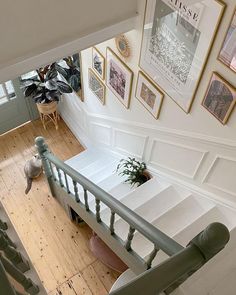 an overhead view of a staircase with pictures on the wall