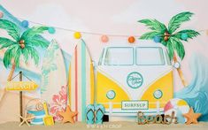 there is a surfboard, starfish, palm trees and a vw bus on the beach