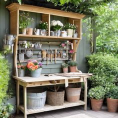 potted plants and gardening tools are displayed on the shelf in this garden shed area