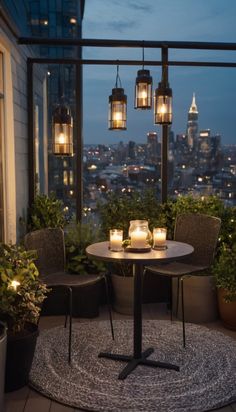 two chairs sitting at a table on top of a balcony next to potted plants