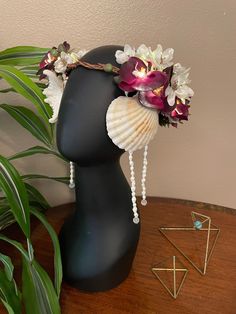 Shells, artificial succulents, and orchids give this headdress mermaid or beach wedding vibes.  This headdress is adorned with intricate design with lots of details, and is lined for a comfortable fit.  It includes fairly lights that have long lasting but exchangeable CR2032 batteries. Includes customized decorative box to protect your headdress during travel. -Circumference: 21", non adjustable.  Can be worn above hairline for larger heads. -Weight: 1lb, 11oz Labyrinth Ball, Flower Head Piece, Shell Crowns, Mermaid Hat, Dark Mermaid, Headpiece Flower, Crown Headpiece, Flower Headdress, Sea Plants