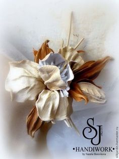 a white and brown flower with the letter p on it