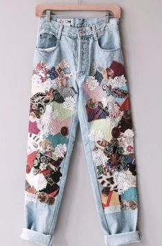 a pair of jeans with patches and flowers on them