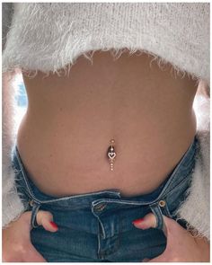 a woman's stomach with her belly piercings on the top and bottom part