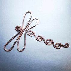 a pair of scissors sitting on top of a white table next to a blue wall