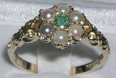 "*This ring is made from 375 9K Yellow Gold with Natural Emerald & Pearls. One center 3mm (0.12\" inches) colorful green Emerald & six Freshwater Pearl all hand set in this charming Solid 9K Yellow Gold Antique style Daisy setting, so full of character. The One central Emerald surrounded by six Elegant Genuine Pearls.  *Height 4mm, Width 10mm, Length 10mm PLEASE MAKE SURE YOU STATE THE FINGER SIZE YOU REQUIRE WITH YOUR PAYMENT AND YOUR TELEPHONE NUMBER FOR DELIVERY. A really impressive ring and unusual in design.  Completely made from Solid English 9K Yellow Gold Hallmarked by the London Assay Office which confirms the rings authenticity. The Hallmark includes the 375 marking for 9K Gold.  This is a delightful piece to wear, comfortable and easy to wear everyday, large enough to be noticed Vintage Green Flower Ring, Green Flower Ring With Birthstone, Green Flower-shaped Ring For May Birthstone, Green Flower Rings For May Birthstone, Green Birthstone Flower Ring, Green Flower-shaped May Birthstone Ring, Green Pearl Round Ring For Anniversary, Green Pearl Ring For Anniversary, Green Emerald Flower Ring For Anniversary