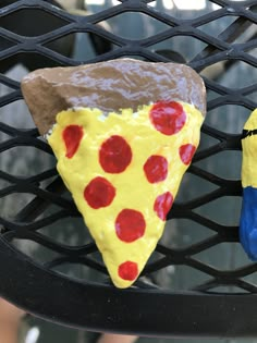 two pieces of pizza sitting on top of a metal grill grate next to each other