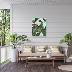 a living room filled with lots of furniture and plants on top of a wooden floor