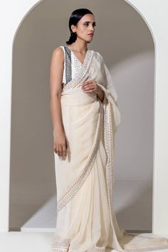 Ivory organza saree with sequin and bead embroidered border. Comes with an unstitched blouse piece. - Aza Fashions Traditional Georgette Pre-draped Saree With Pearl Embroidery, Festive White Pre-draped Saree With Pearl Embroidery, Elegant White Tissue Silk Pre-draped Saree, Bollywood Style White Pre-draped Saree With Pearl Embroidery, Elegant Organza Pre-draped Saree For Navratri, White Georgette Pre-draped Saree With Pearl Embroidery, Traditional Pre-draped Saree With Pearl Embroidery, Elegant Organza Pre-draped Saree With Mirror Work, White Georgette Saree With Pearl Embroidery