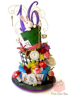 a cake that is made to look like it has an odd hat and clock on top