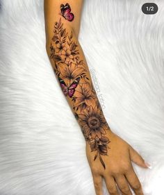 a woman's arm with flowers and butterflies on it