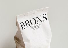 a brown paper bag with the word brons on it sitting in front of a white wall