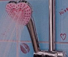 a shower head with two hearts attached to it