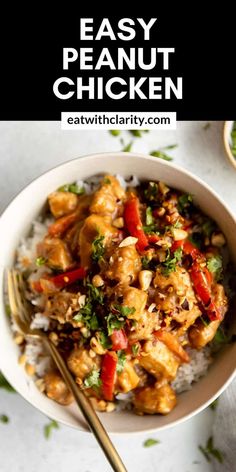 a white bowl filled with chicken and rice on top of a table next to a fork