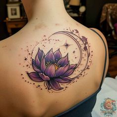 a woman's back with a lotus tattoo on her shoulder and the moon in the background