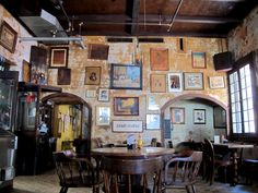 an old fashioned restaurant with many pictures on the wall