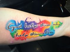 a person with a colorful tattoo on their arm that says, god help you those who help themselves