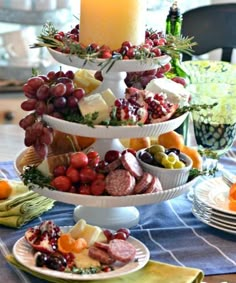 three tiered trays filled with food on top of a table