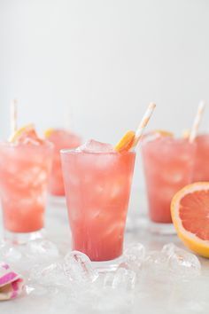 three glasses filled with pink lemonade and garnished with toothpicks