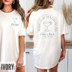 a woman wearing a white t - shirt with an image of a martini on it