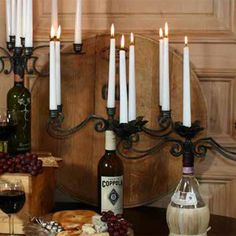 a table topped with wine bottles and candles